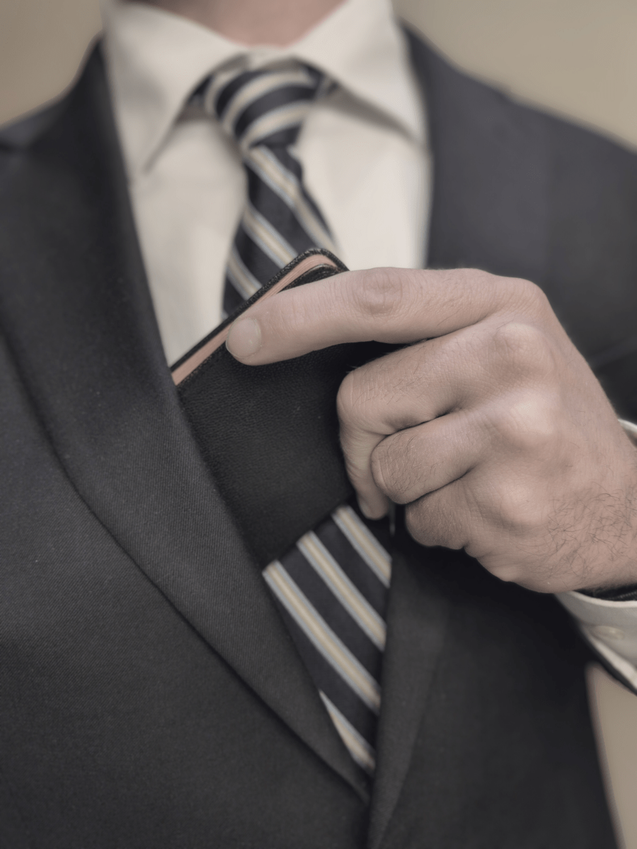 Person placing religious book into coat pocket