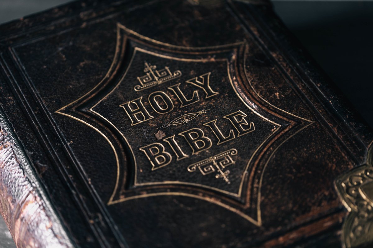 Close-up of an old leather-bound Bible with 'HOLY BIBLE' embossed on the cover.